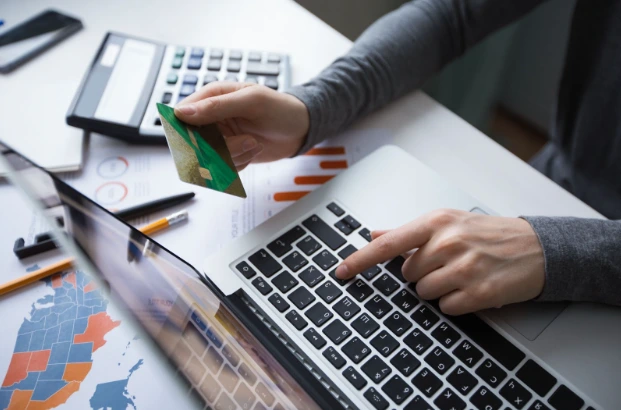 A person typing credit card details.